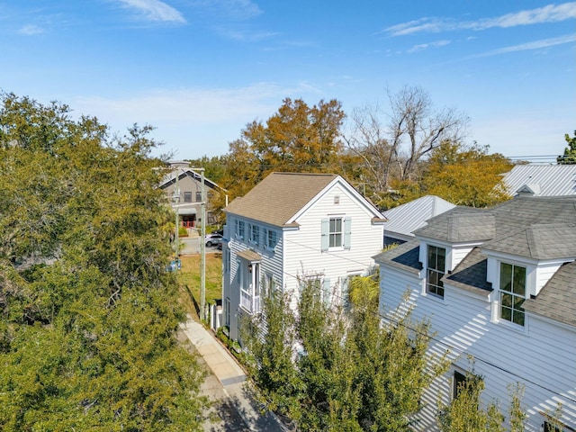 view of side of property featuring roof with shingles