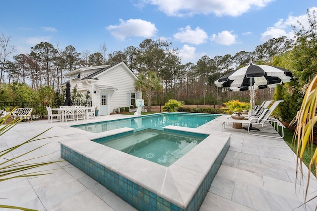 view of pool featuring an in ground hot tub and a patio area