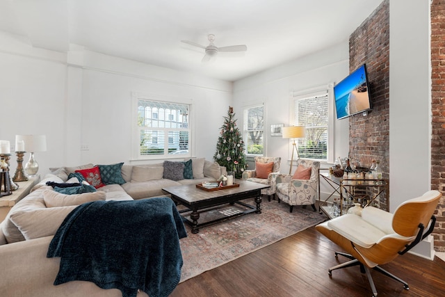 living room featuring ceiling fan, plenty of natural light, and hardwood / wood-style flooring