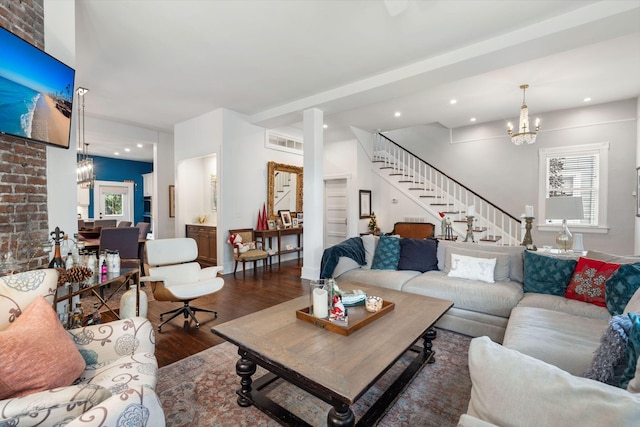 living room featuring dark hardwood / wood-style floors and an inviting chandelier