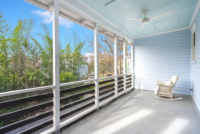 unfurnished sunroom featuring ceiling fan