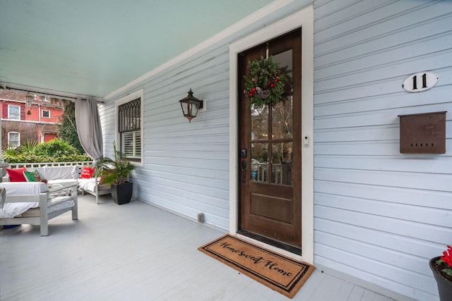 view of exterior entry with a porch