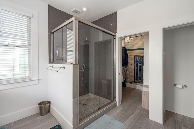 bathroom with a healthy amount of sunlight and a shower with door