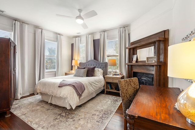 bedroom with ceiling fan and dark hardwood / wood-style flooring