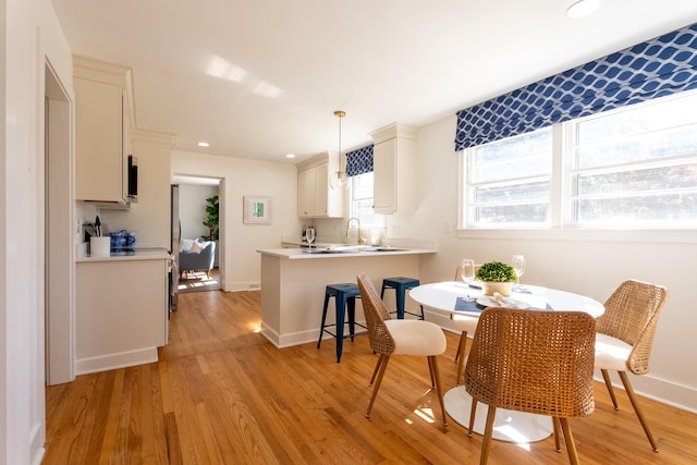 dining area featuring light hardwood / wood-style floors and sink