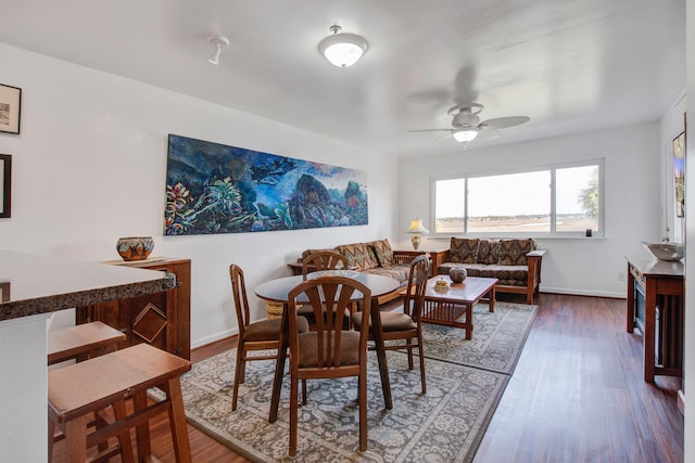 dining room with baseboards, a ceiling fan, and wood finished floors