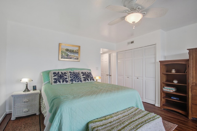 bedroom featuring a closet, visible vents, ceiling fan, and wood finished floors