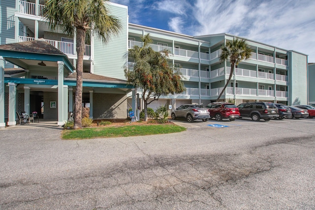 view of building exterior with uncovered parking