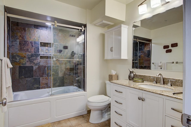 bathroom featuring enclosed tub / shower combo, tile patterned floors, toilet, and vanity