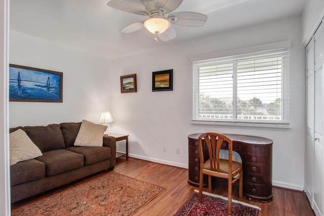 living area with ceiling fan, baseboards, and wood finished floors