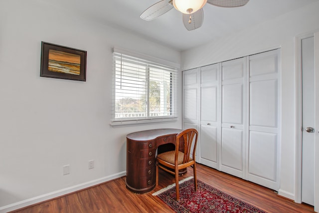 office area featuring a ceiling fan, wood finished floors, and baseboards