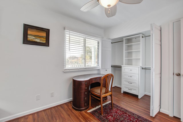 office space with baseboards, ceiling fan, and dark wood-style flooring