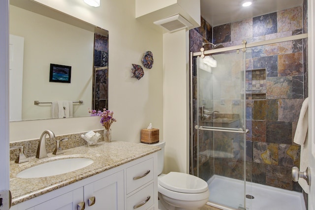 full bathroom with visible vents, toilet, a stall shower, and vanity