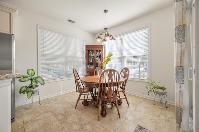 dining area featuring a chandelier and plenty of natural light