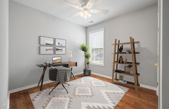 home office featuring hardwood / wood-style floors and ceiling fan