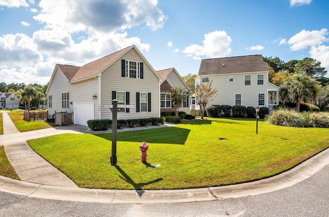 view of front of property featuring a front lawn and a garage