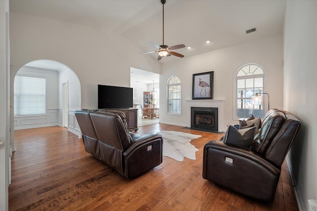 living room with high vaulted ceiling, wood-type flooring, and ceiling fan