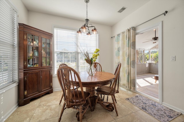 dining area with ceiling fan with notable chandelier and plenty of natural light