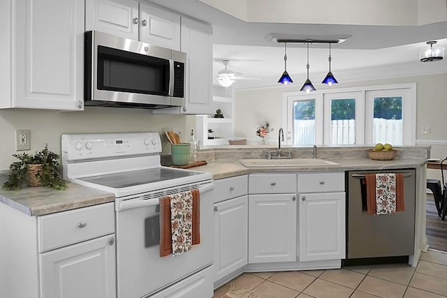 kitchen with stainless steel appliances, white cabinetry, kitchen peninsula, and sink