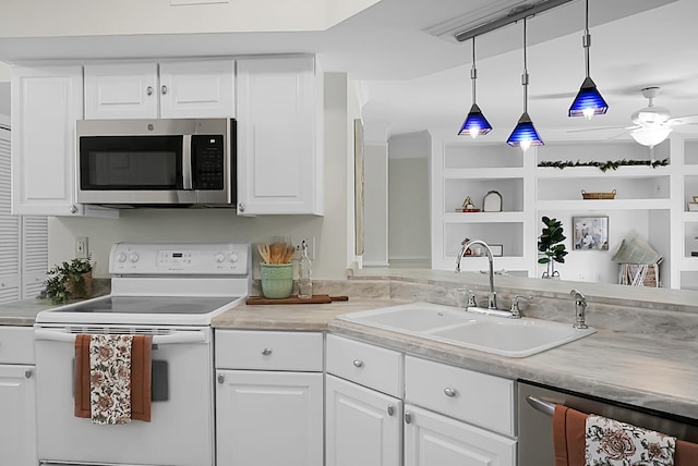 kitchen featuring pendant lighting, sink, white cabinetry, appliances with stainless steel finishes, and ceiling fan