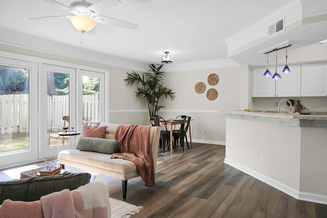 living room with sink, ceiling fan, dark hardwood / wood-style floors, and crown molding