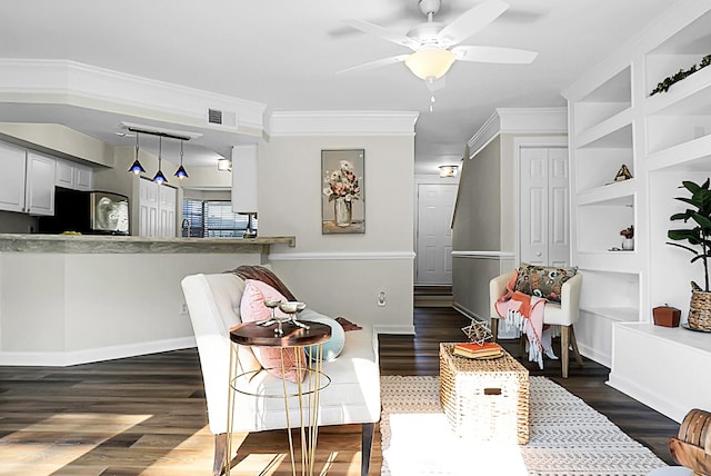 interior space with ornamental molding, built in shelves, ceiling fan, and dark hardwood / wood-style floors