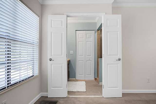 unfurnished bedroom featuring light carpet, a closet, and crown molding