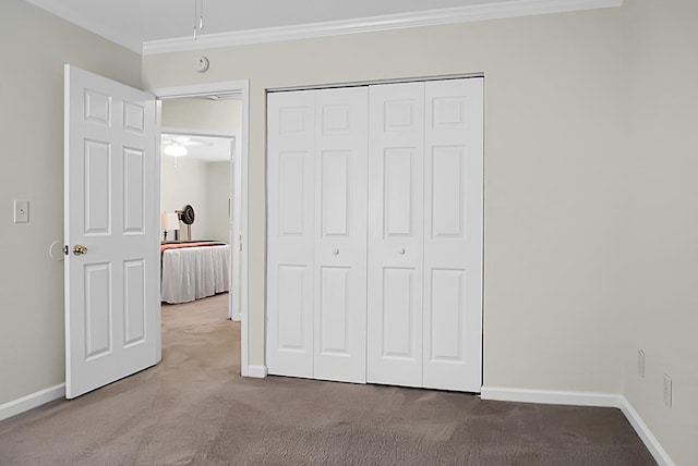 unfurnished bedroom with light carpet, a closet, and crown molding