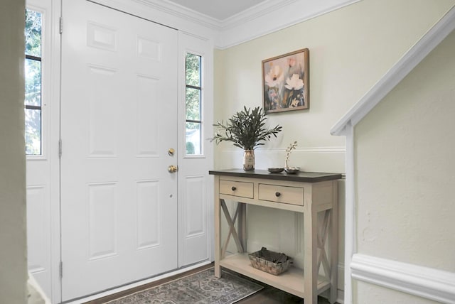 entrance foyer featuring a healthy amount of sunlight and crown molding