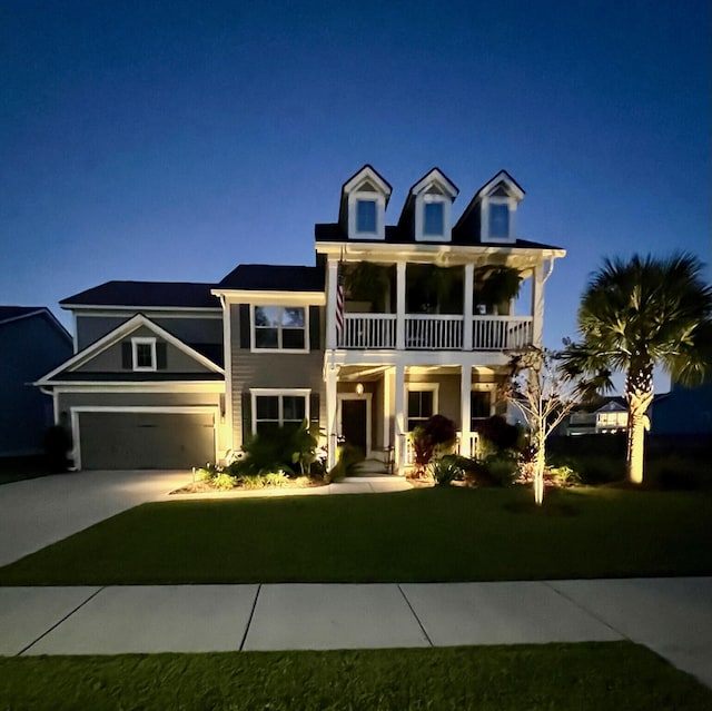 view of front of property with a balcony and a front lawn