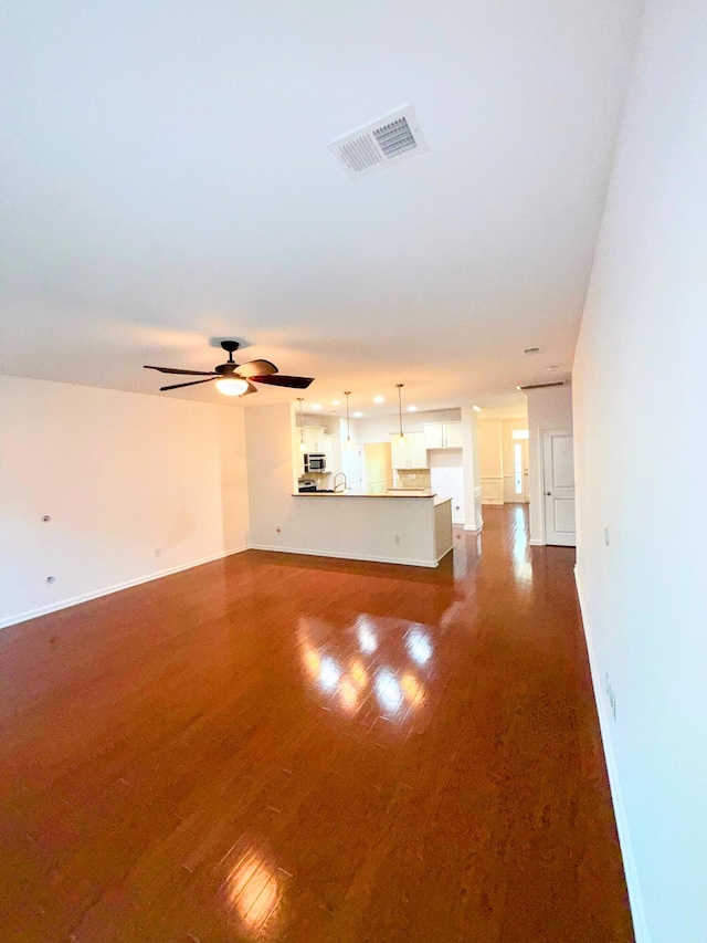 332 Southern Sugar Ave, Moncks Corner, SC 29461 - unfurnished living room featuring dark wood-type flooring, baseboards, and a ceiling fan