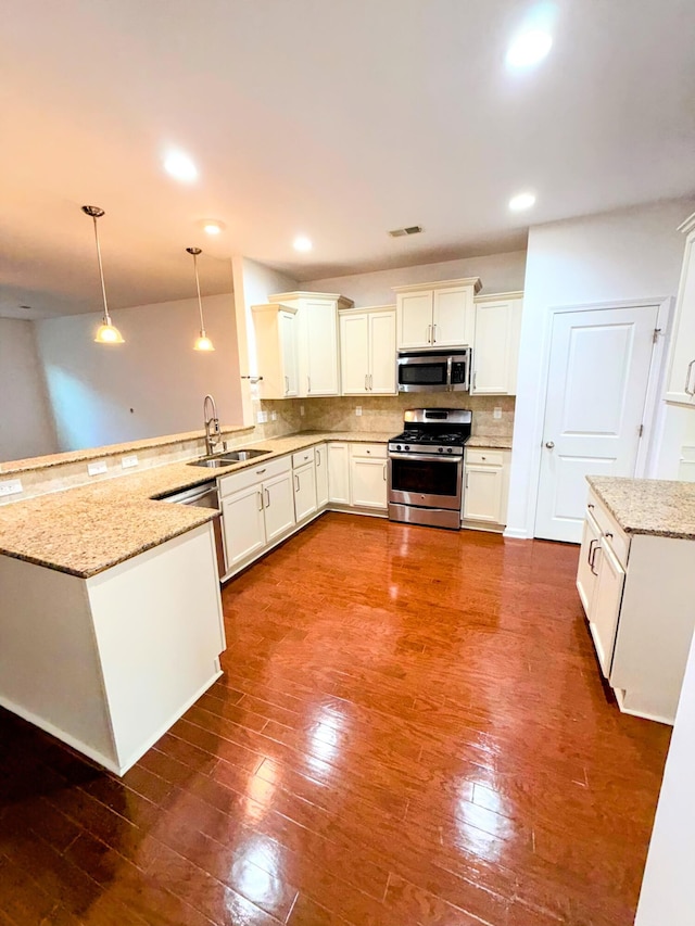 332 Southern Sugar Ave, Moncks Corner, SC 29461 - kitchen featuring stainless steel appliances, a sink, a peninsula, backsplash, and light stone countertops