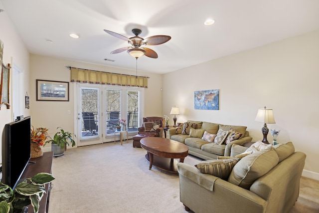 carpeted living room featuring ceiling fan