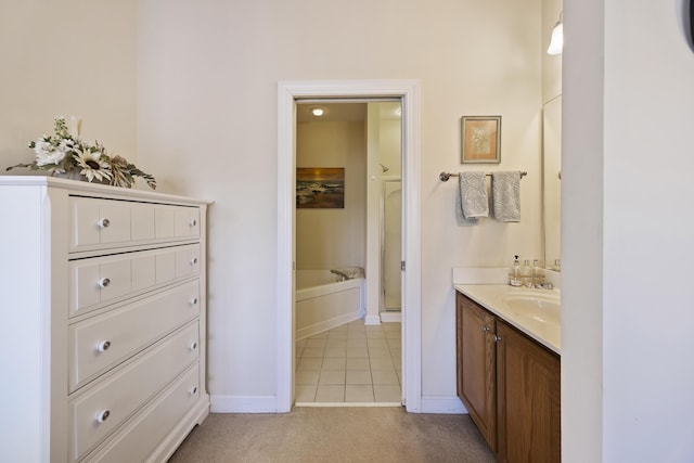 bathroom with vanity, tile patterned floors, and a bath