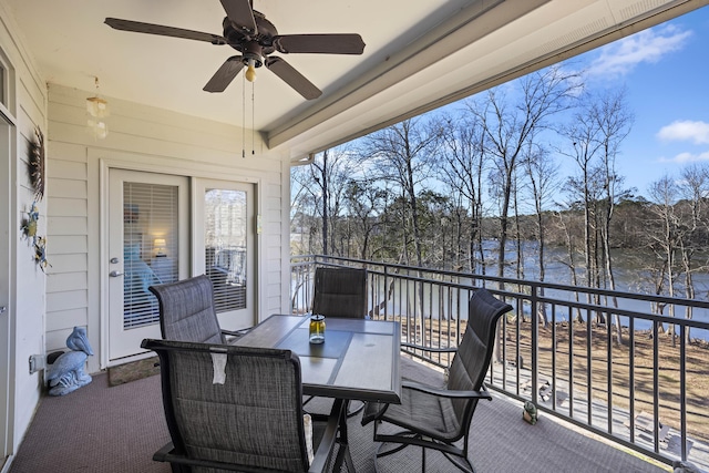 exterior space with ceiling fan, a healthy amount of sunlight, and a water view