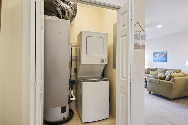 laundry room with light carpet, stacked washer and dryer, and gas water heater