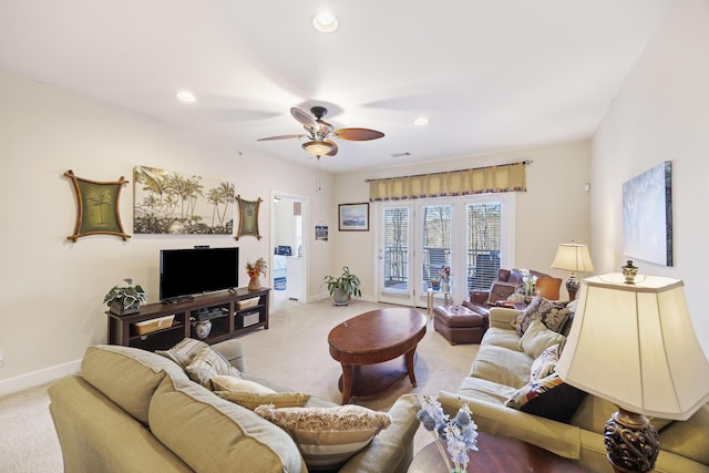 carpeted living room featuring ceiling fan