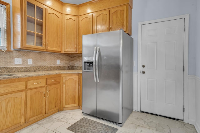 kitchen with tasteful backsplash, sink, and stainless steel fridge