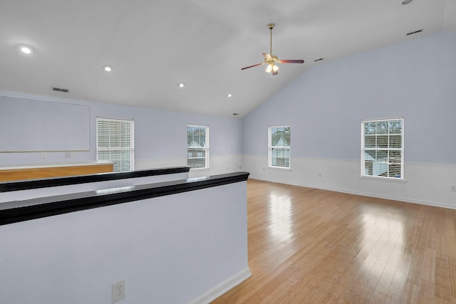 kitchen featuring light hardwood / wood-style flooring, ceiling fan, and vaulted ceiling