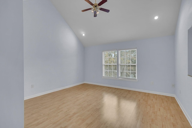 empty room with high vaulted ceiling, light hardwood / wood-style floors, and ceiling fan