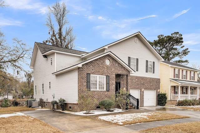 front facade featuring a garage and central air condition unit