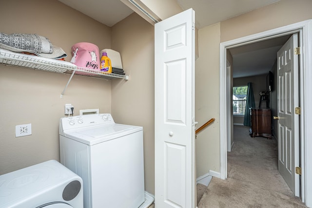 washroom featuring washer / clothes dryer, light colored carpet, baseboards, and laundry area