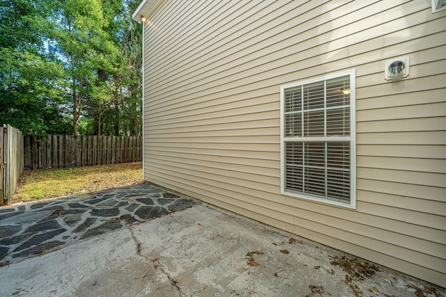 view of home's exterior with a patio and a fenced backyard