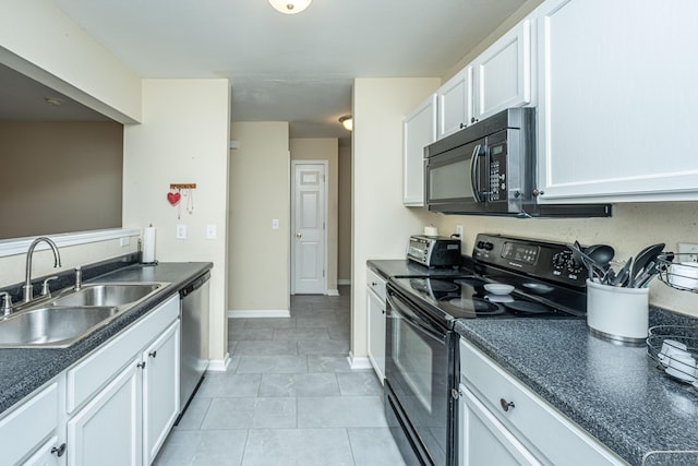 kitchen featuring light tile patterned floors, dark countertops, white cabinetry, a sink, and black appliances