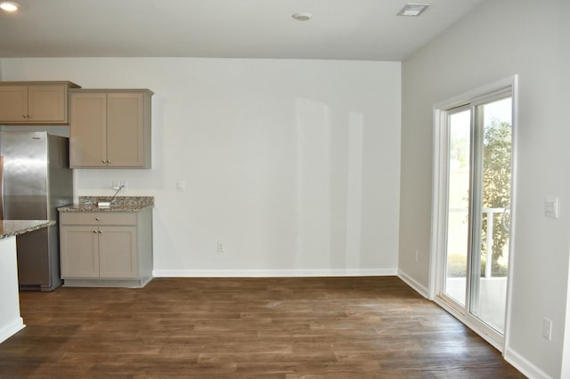 unfurnished dining area with visible vents, baseboards, and dark wood-type flooring