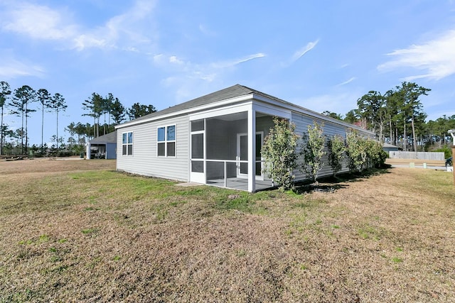 exterior space with a yard and a sunroom