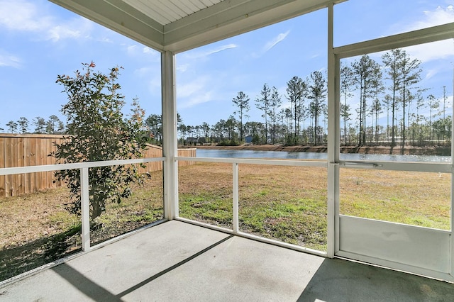 unfurnished sunroom featuring a healthy amount of sunlight and a water view