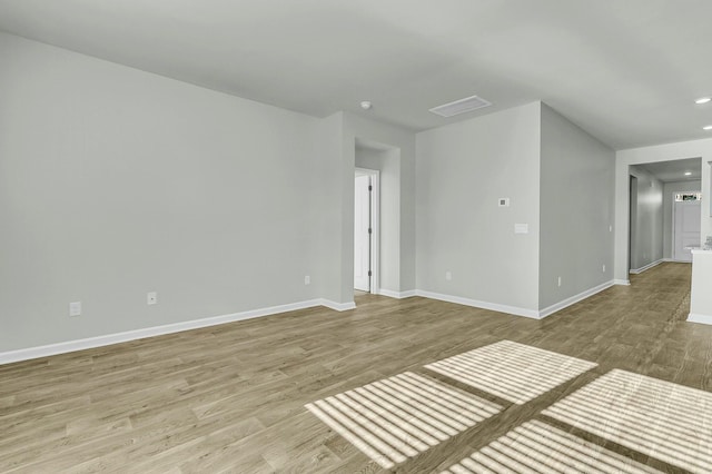 unfurnished room with recessed lighting, baseboards, visible vents, and light wood finished floors