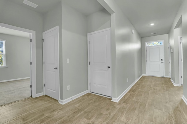 entrance foyer with light wood-style floors and baseboards