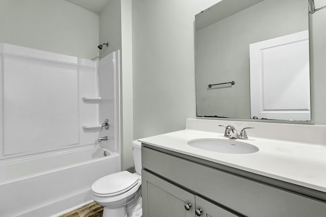 bathroom featuring shower / bathtub combination, toilet, wood finished floors, and vanity